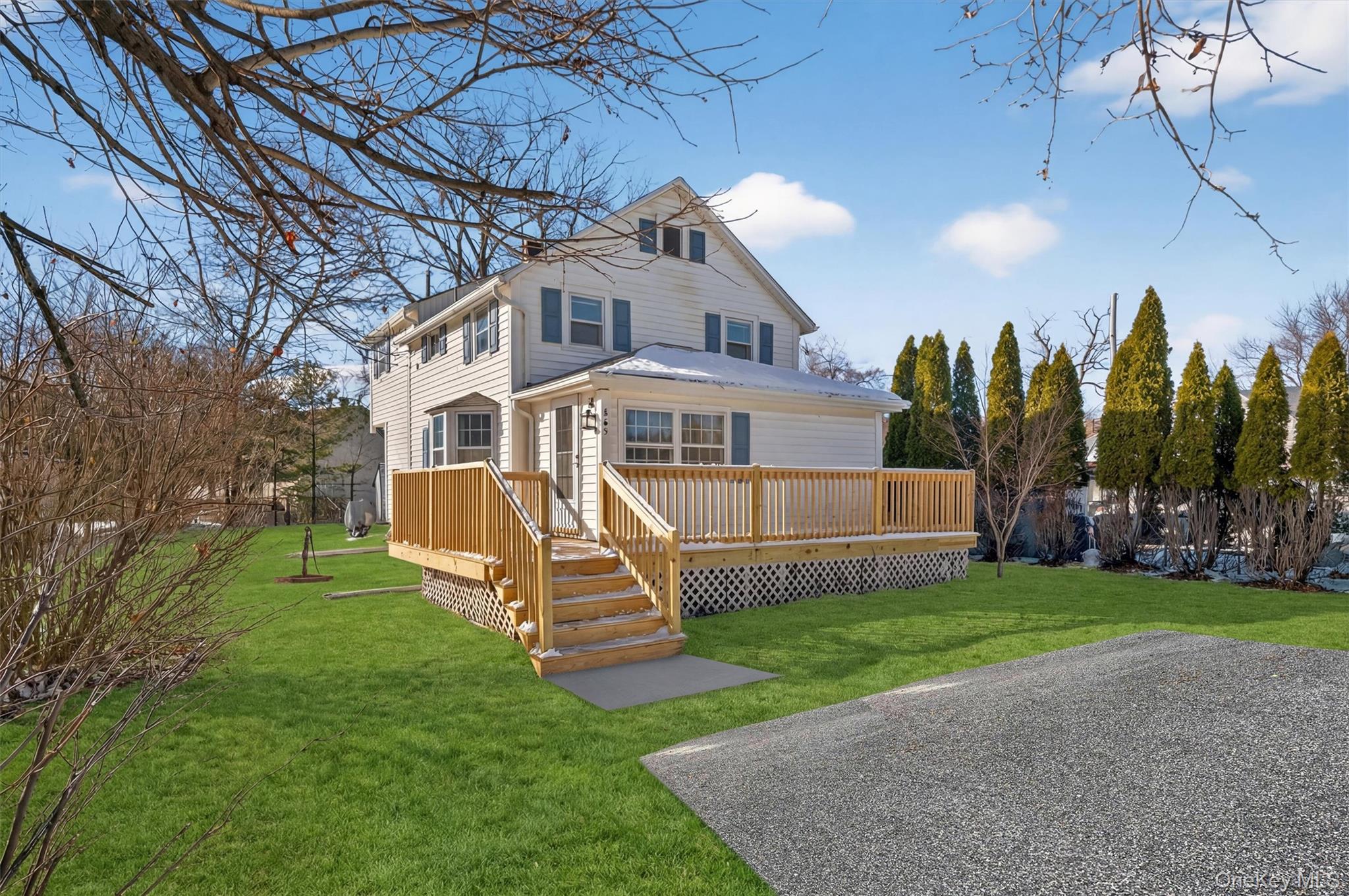 a view of a house with a yard deck and a slide