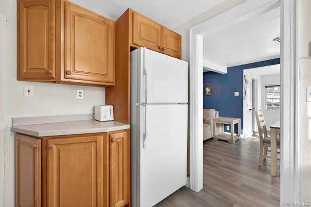a kitchen with stainless steel appliances a refrigerator and a cabinets
