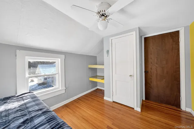 a view of a house with backyard and a trees