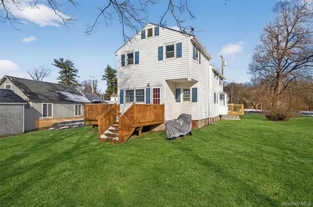 a front view of a house with a yard table and chairs