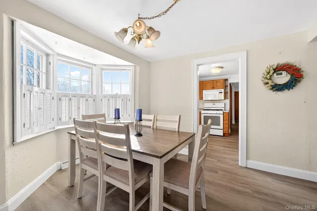 a view of a dining room with furniture window and wooden floor