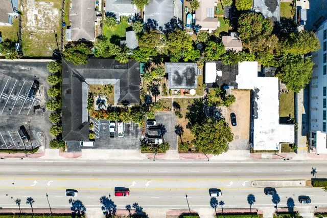 an aerial view of a house with a yard and lake view