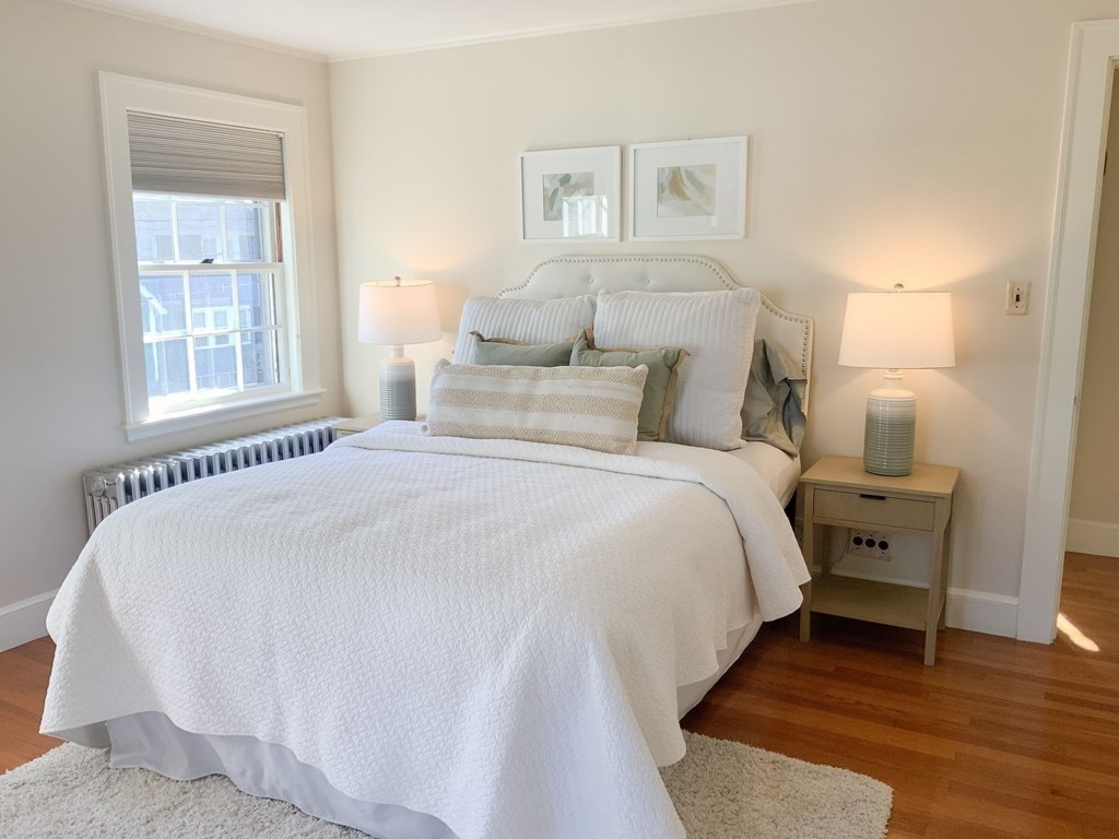 31 Grandview Road Arlington, MA 02476 - Photo 12 of 22 a bedroom with a bed and wooden floor