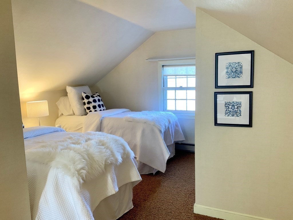31 Grandview Road Arlington, MA 02476 - Photo 19 of 22 a bedroom with a bed and wall painting