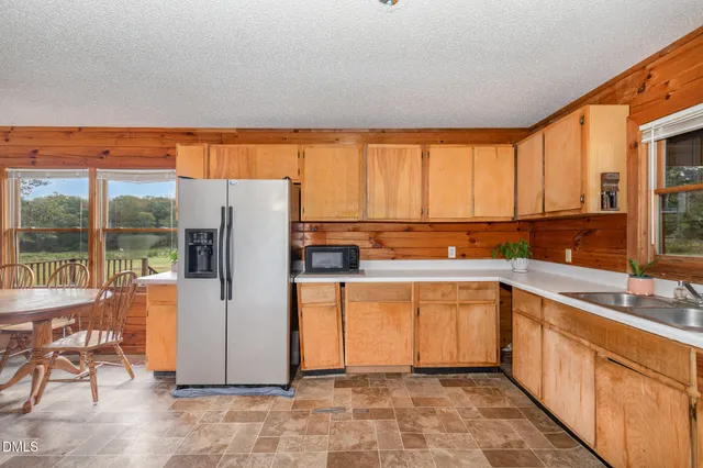 a kitchen with stainless steel appliances a refrigerator sink and cabinets