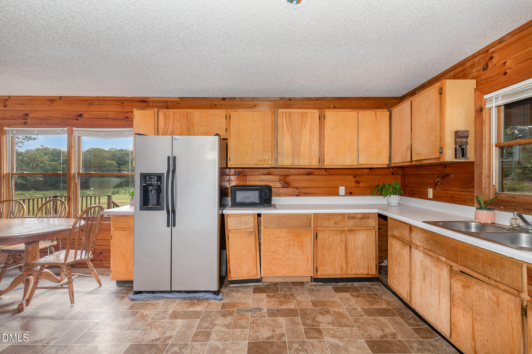 3018 University Station Road Durham, NC 27705 - Photo 13 of 32 a kitchen with stainless steel appliances a refrigerator sink and cabinets