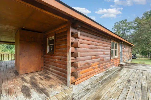 a view of backyard with wooden floor and fence