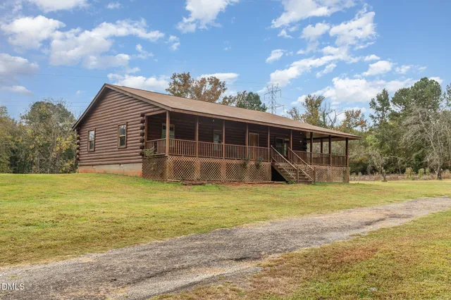 a view of a house with a backyard and pool