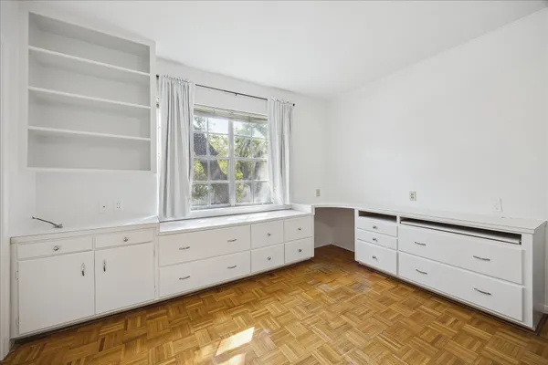 a room with white cabinets and a window