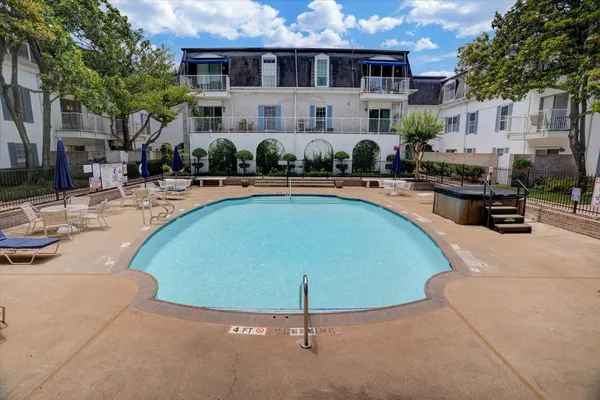 a view of a house with swimming pool and sitting area