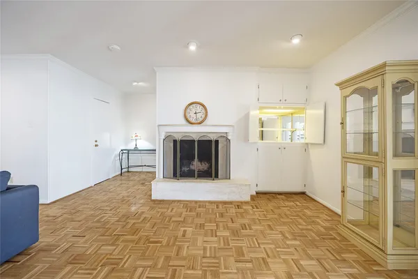a view of a livingroom with wooden floor and a fireplace