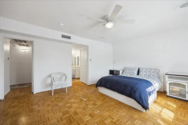 a bedroom with a bed and a chair