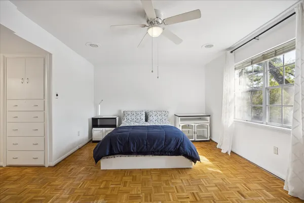 a bedroom with a bed and a window