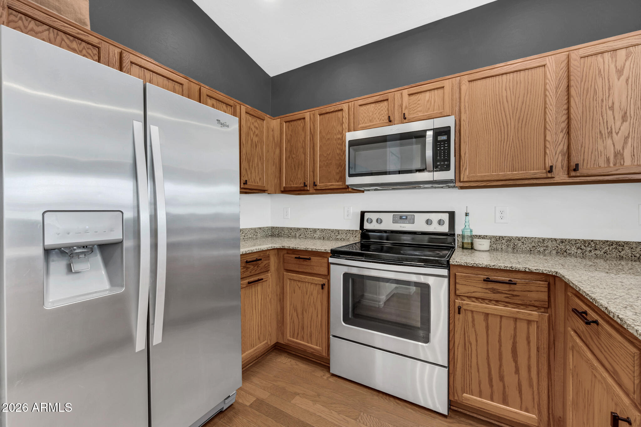 5627 South 21st Terrace Phoenix, AZ 85040 - Photo 12 of 32 a kitchen with granite countertop a stove microwave and refrigerator
