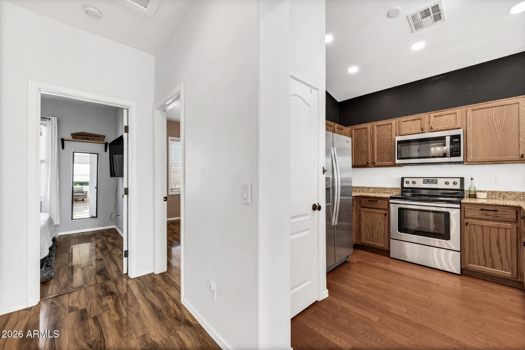 5627 South 21st Terrace Phoenix, AZ 85040 - Photo 13 of 32 a kitchen with stainless steel appliances a microwave a stove and a refrigerator