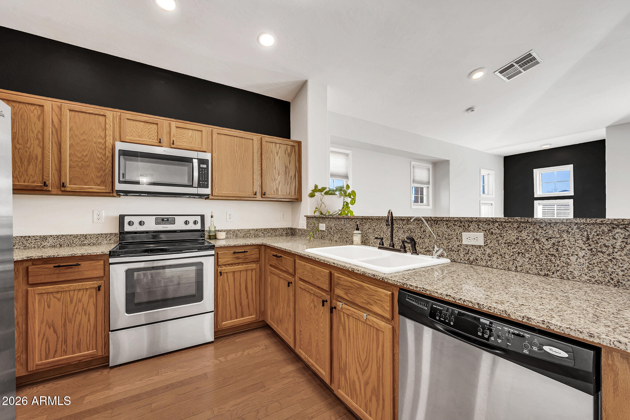 5627 South 21st Terrace Phoenix, AZ 85040 - Photo 15 of 32 a kitchen with a sink stove and microwave