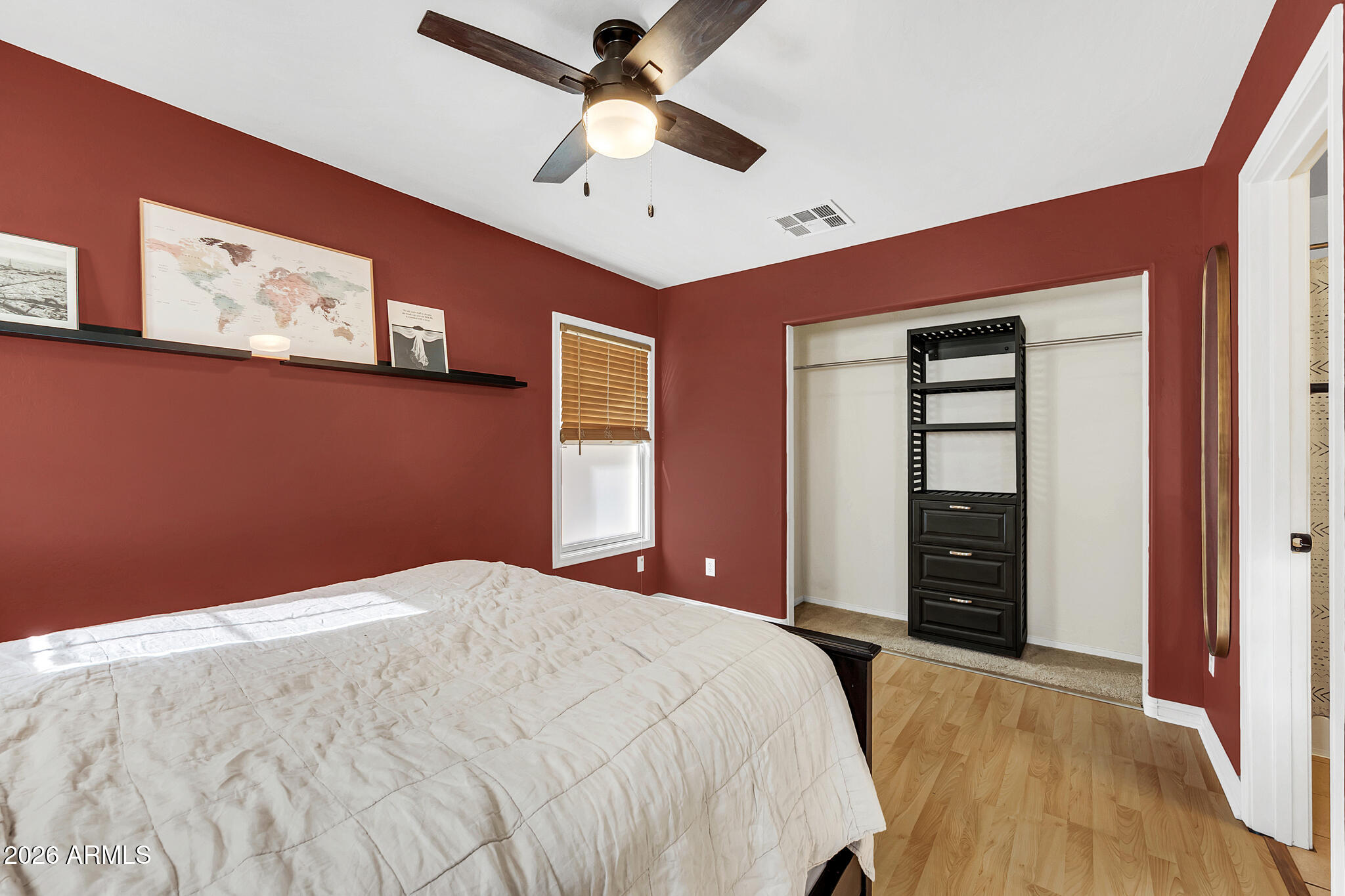 5627 South 21st Terrace Phoenix, AZ 85040 - Photo 18 of 32 a bedroom with a large bed and a chandelier