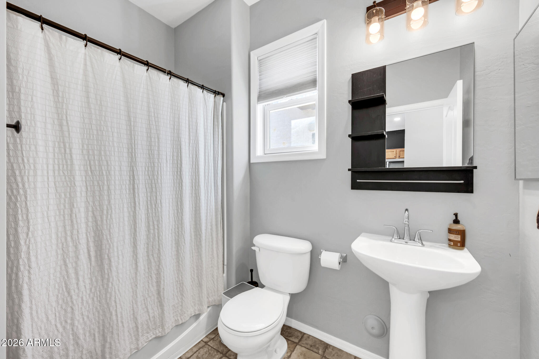 5627 South 21st Terrace Phoenix, AZ 85040 - Photo 25 of 32 a bathroom with a toilet sink and mirror