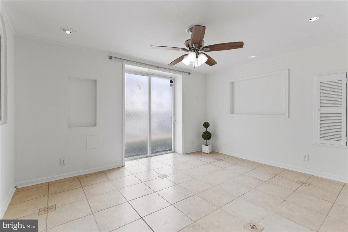 202 Buckingham Lane, Unit 102 Stafford, VA 22556 - Photo 15 of 37 a view of an empty room and window a ceiling fan