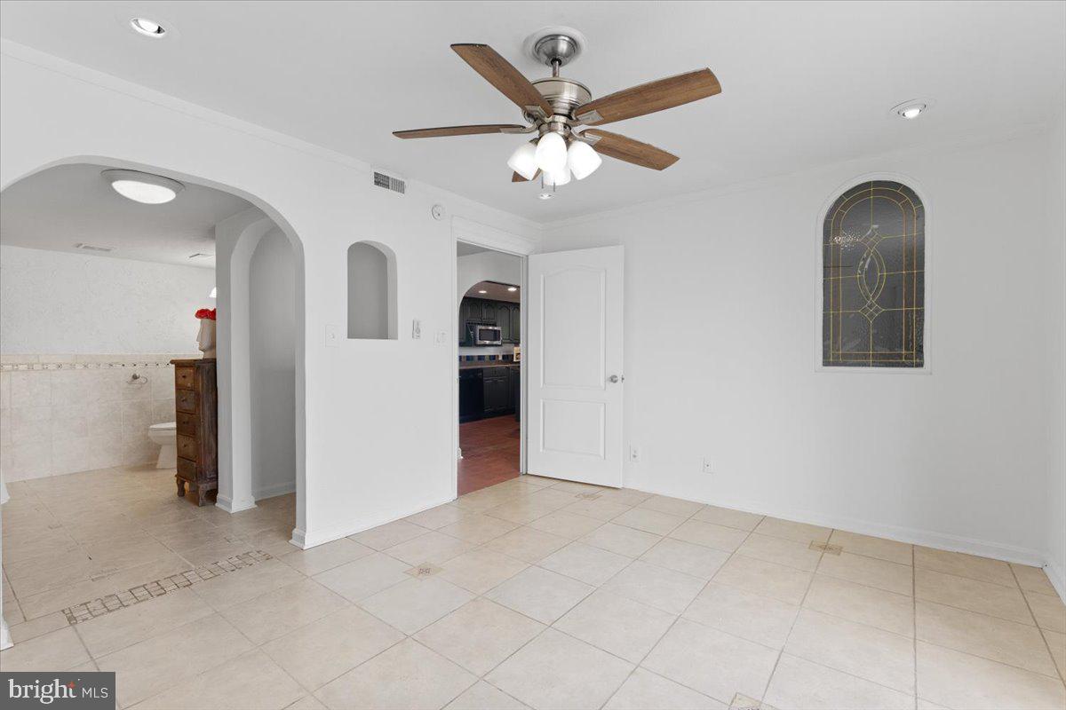 202 Buckingham Lane, Unit 102 Stafford, VA 22556 - Photo 16 of 37 an empty room with closet and fan
