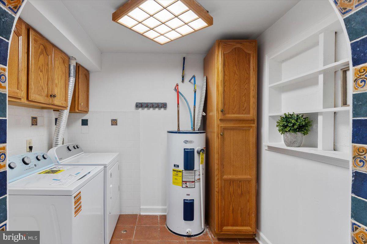 202 Buckingham Lane, Unit 102 Stafford, VA 22556 - Photo 24 of 37 a utility room with sink dryer and washer