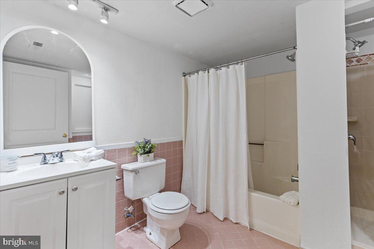 202 Buckingham Lane, Unit 102 Stafford, VA 22556 - Photo 25 of 37 a bathroom with a sink a toilet and shower