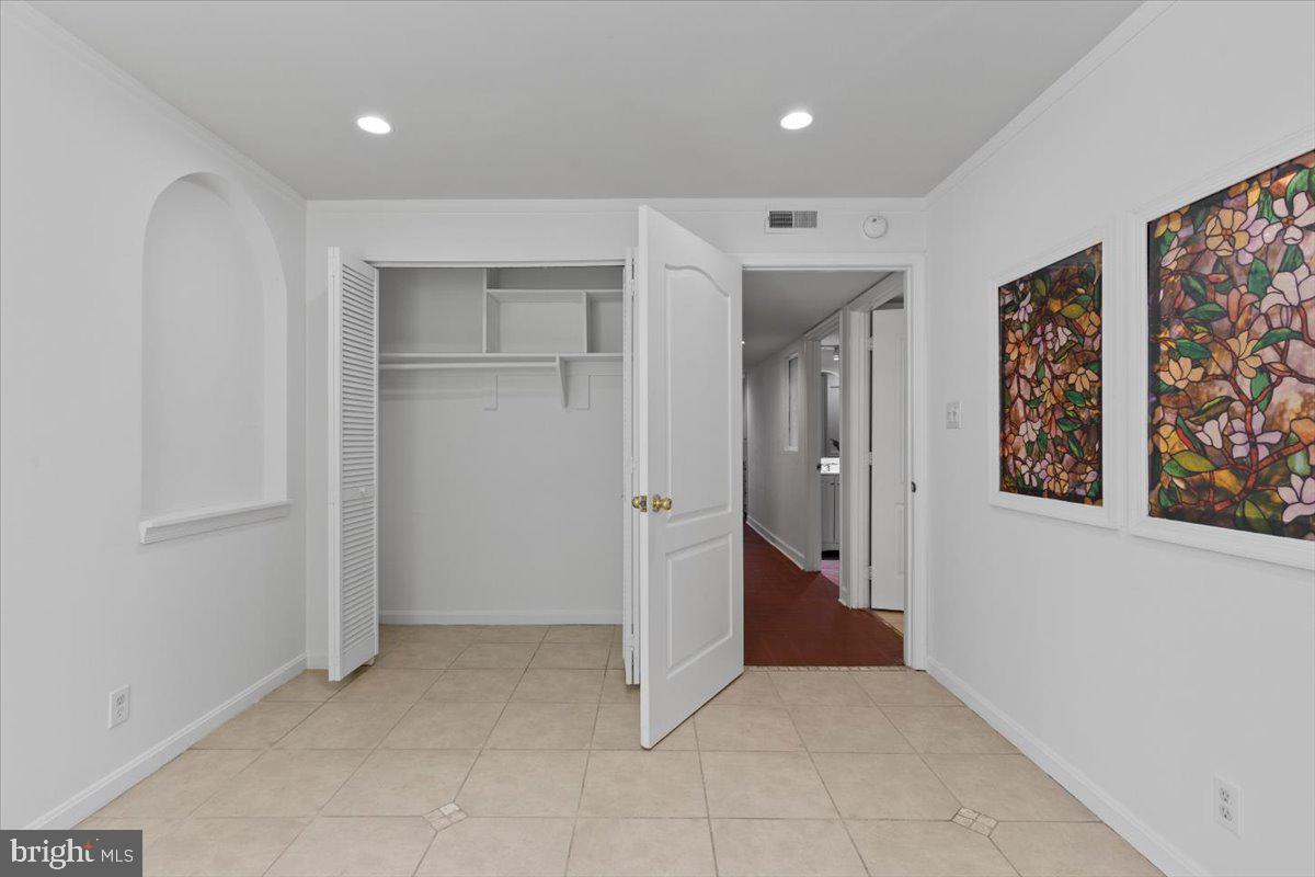 202 Buckingham Lane, Unit 102 Stafford, VA 22556 - Photo 30 of 37 wooden floor in a room with windows and closet