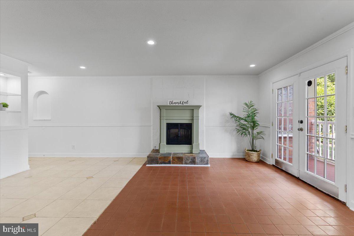 202 Buckingham Lane, Unit 102 Stafford, VA 22556 - Photo 7 of 37 a view of an empty room with a fireplace and a window
