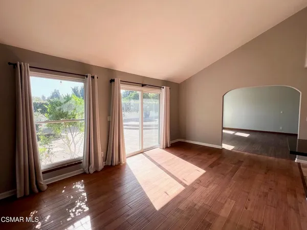 a view of an empty room with glass door