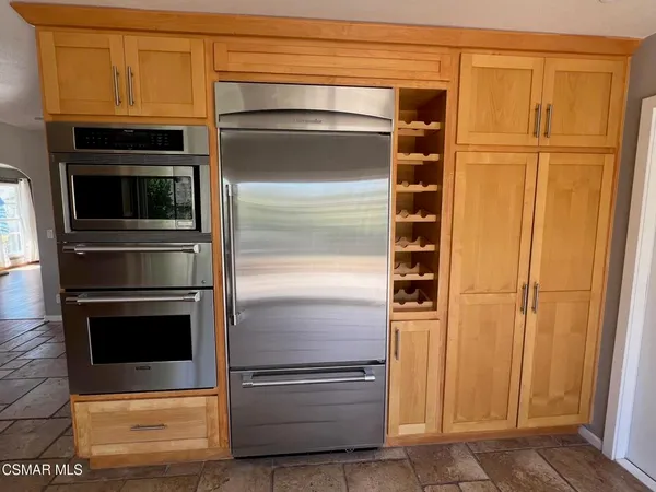 a kitchen with stainless steel appliances a stove a microwave and a refrigerator