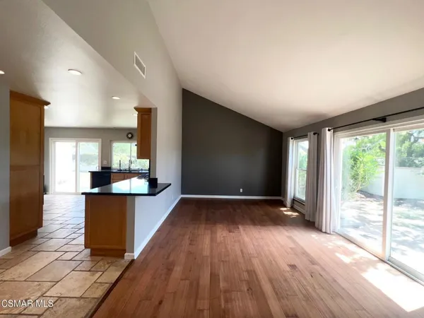 a view of kitchen with sink and wooden floor