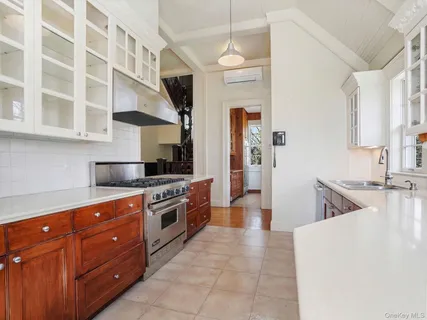 a large kitchen with stainless steel appliances granite countertop a sink and a stove