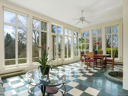 a living room with fireplace furniture and a large window