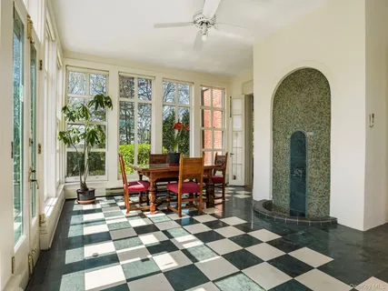 a room with patio furniture and a floor to ceiling window