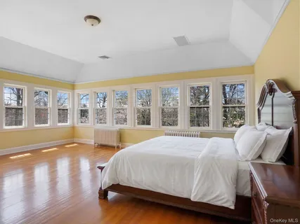 a spacious bedroom with a large bed and a large window