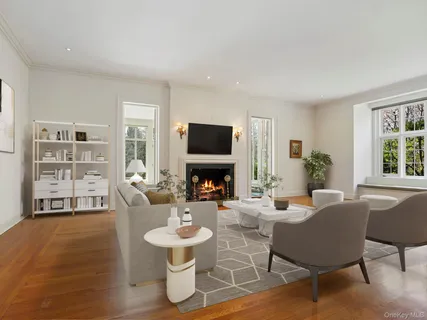 a living room with furniture a fireplace and a window