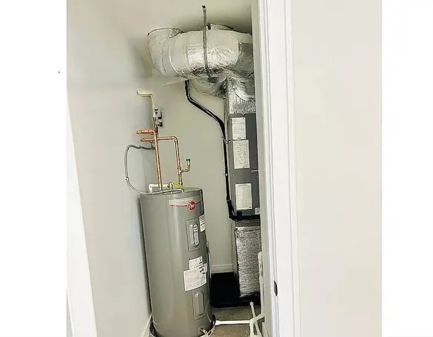 a room with a chandelier and wooden floor