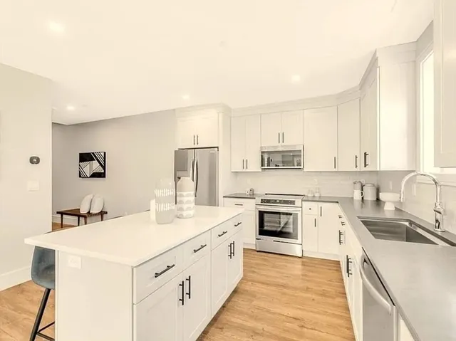 a kitchen with a sink stove and refrigerator