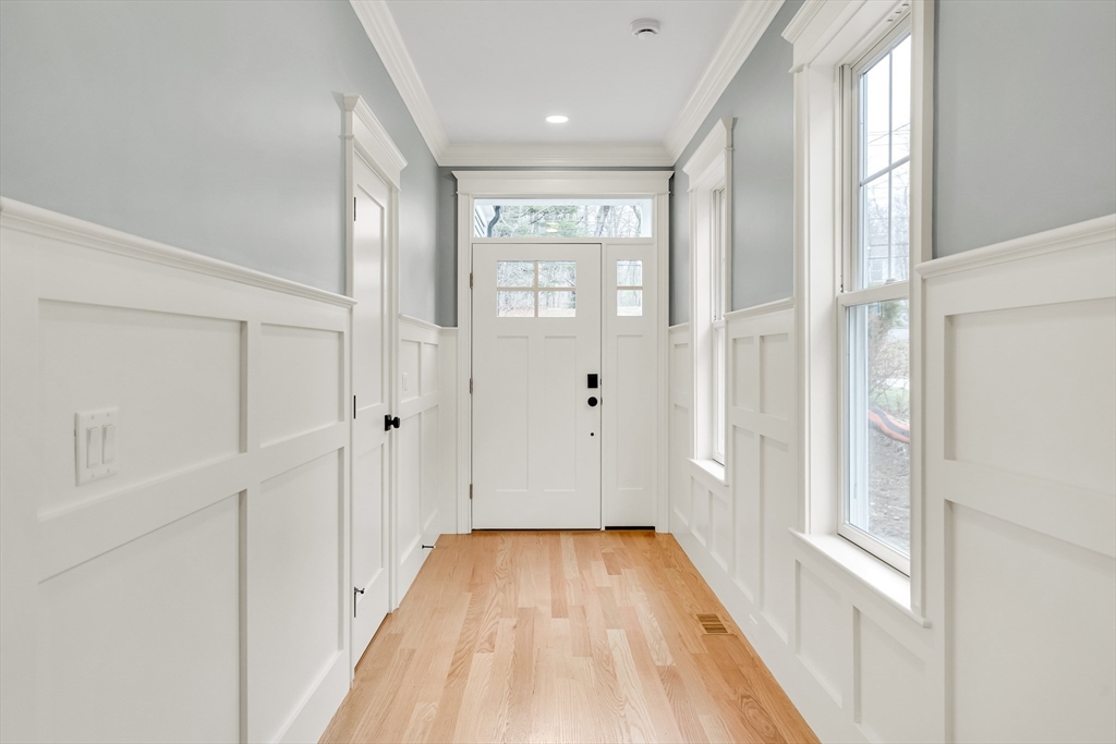 232 Lincoln Street Lexington, MA 02421 - Photo 2 of 41 a view of a hallway with wooden floor and staircase