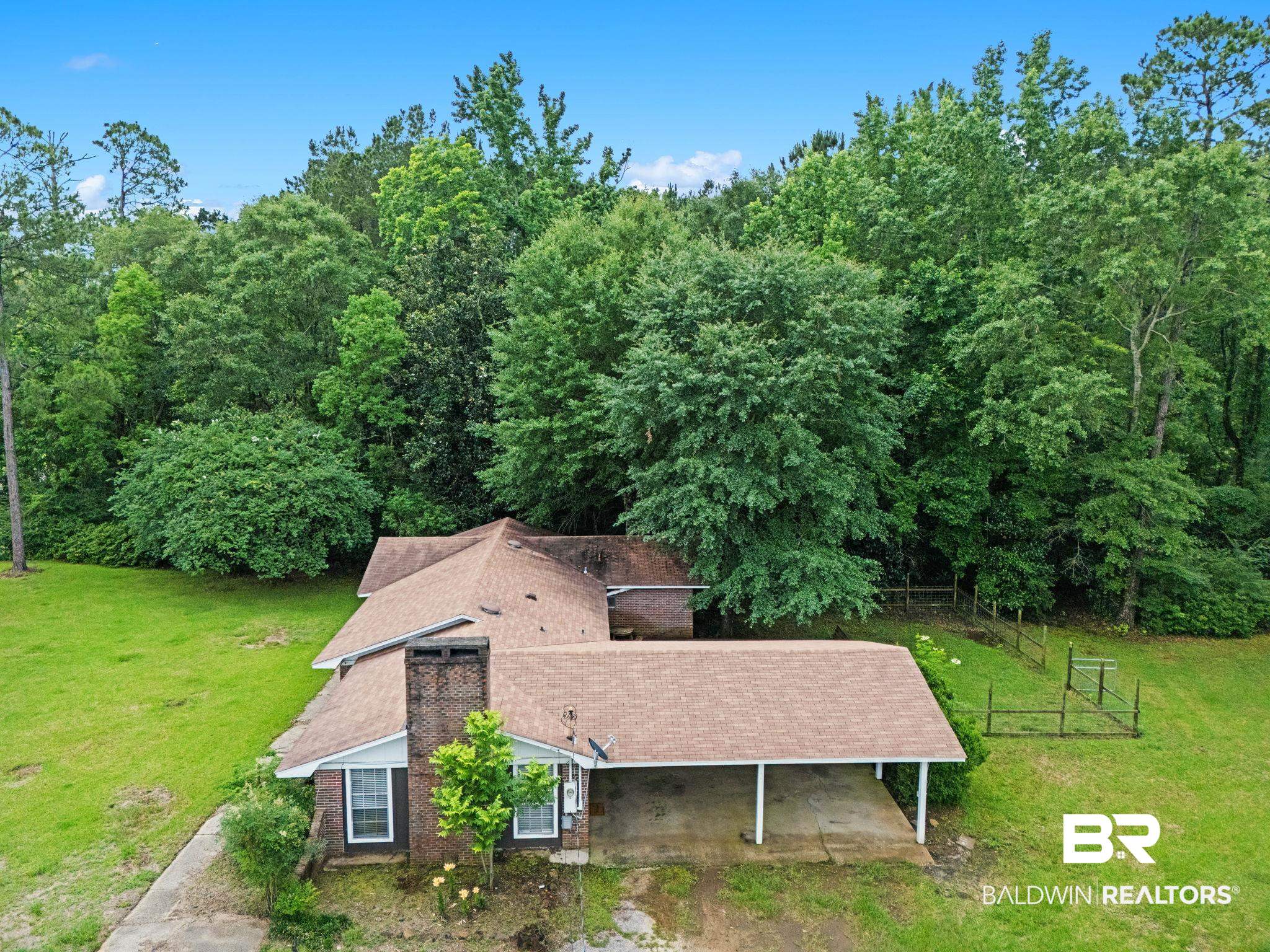 384 Old Bratt Road Atmore, AL 36502 - Photo 54 of 64 Brown shingled roofline atop a brick exterior