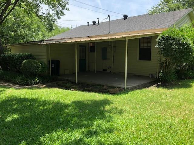 602 West 3rd Street Justin, TX 76247 - Photo 19 of 22 Expansive backyard featuring a covered patio, concrete slab, and mature landscaping