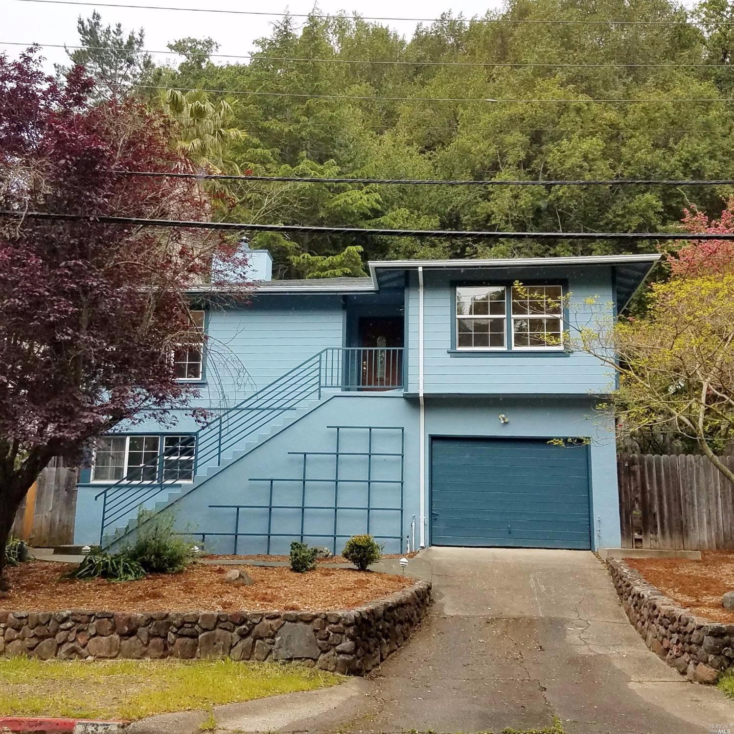 137 Butterfield Road San Anselmo, CA 94960 - Photo 1 of 1 a front view of a house with a yard and garage