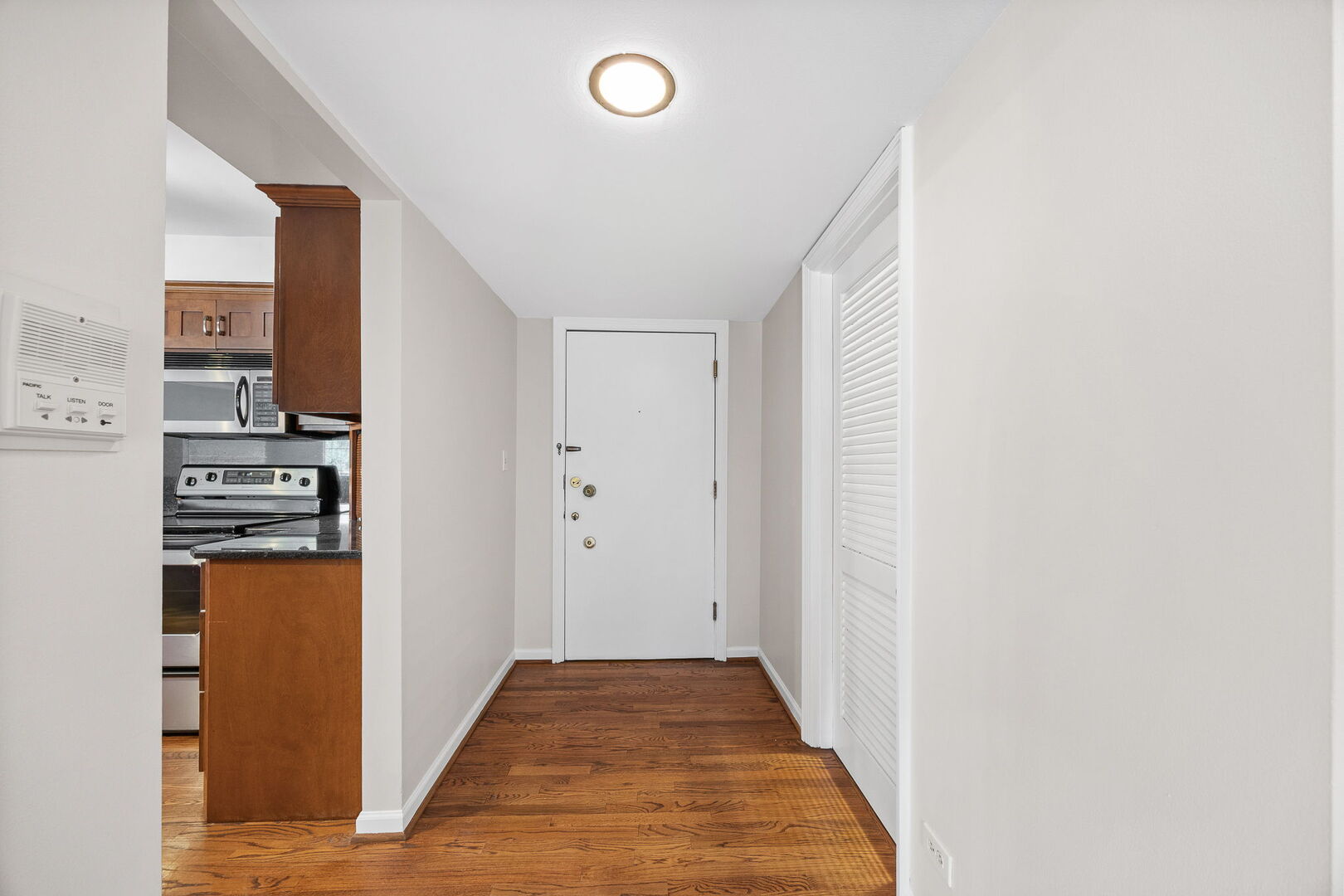 124 Carriage Way Drive, Unit B109 Burr Ridge, IL 60527 - Photo 6 of 31 a view of a kitchen from the hallway