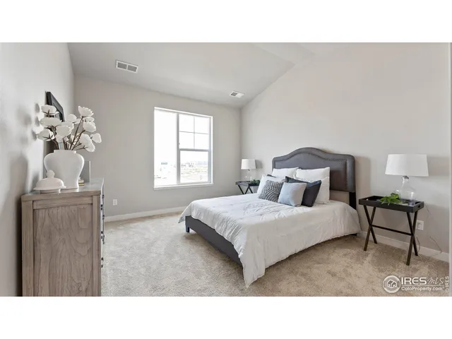 a living room with a bed furniture and a window
