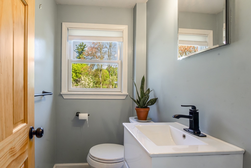 196 Center Street Groveland, MA 01834 - Photo 11 of 32 a bathroom with a sink mirror and toilet