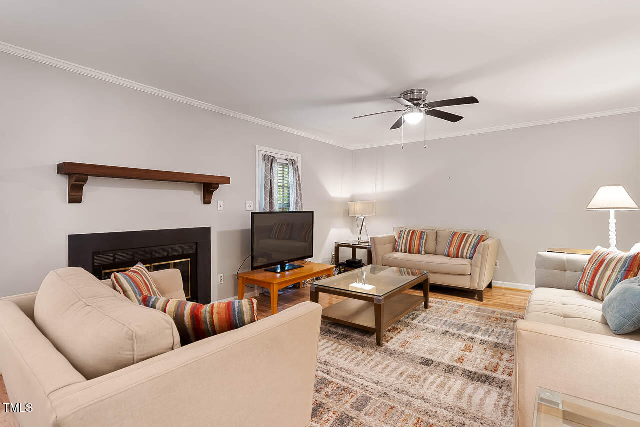 5525 Middleton Road Durham, NC 27713 - Photo 17 of 38 a living room with furniture a fireplace and a flat screen tv