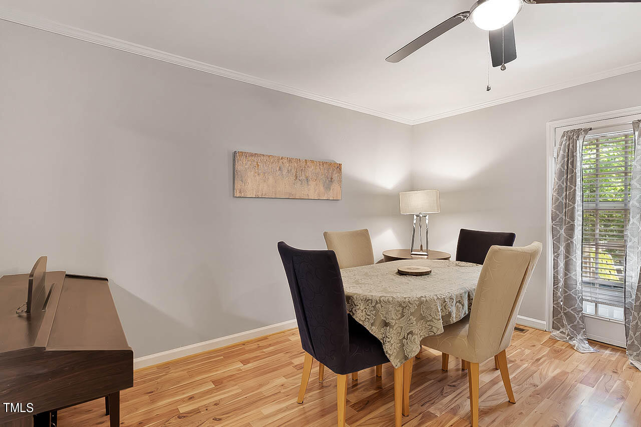 5525 Middleton Road Durham, NC 27713 - Photo 19 of 38 a view of a dining room with furniture and wooden floor