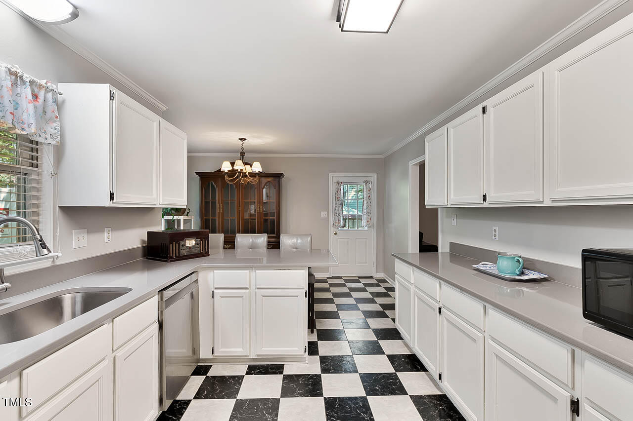 5525 Middleton Road Durham, NC 27713 - Photo 23 of 38 a kitchen with a sink a stove and cabinets