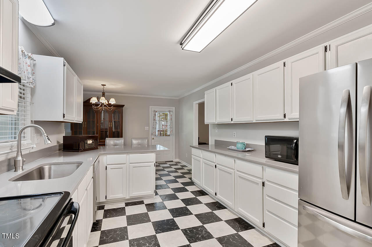 5525 Middleton Road Durham, NC 27713 - Photo 26 of 38 a kitchen with a sink a stove and refrigerator