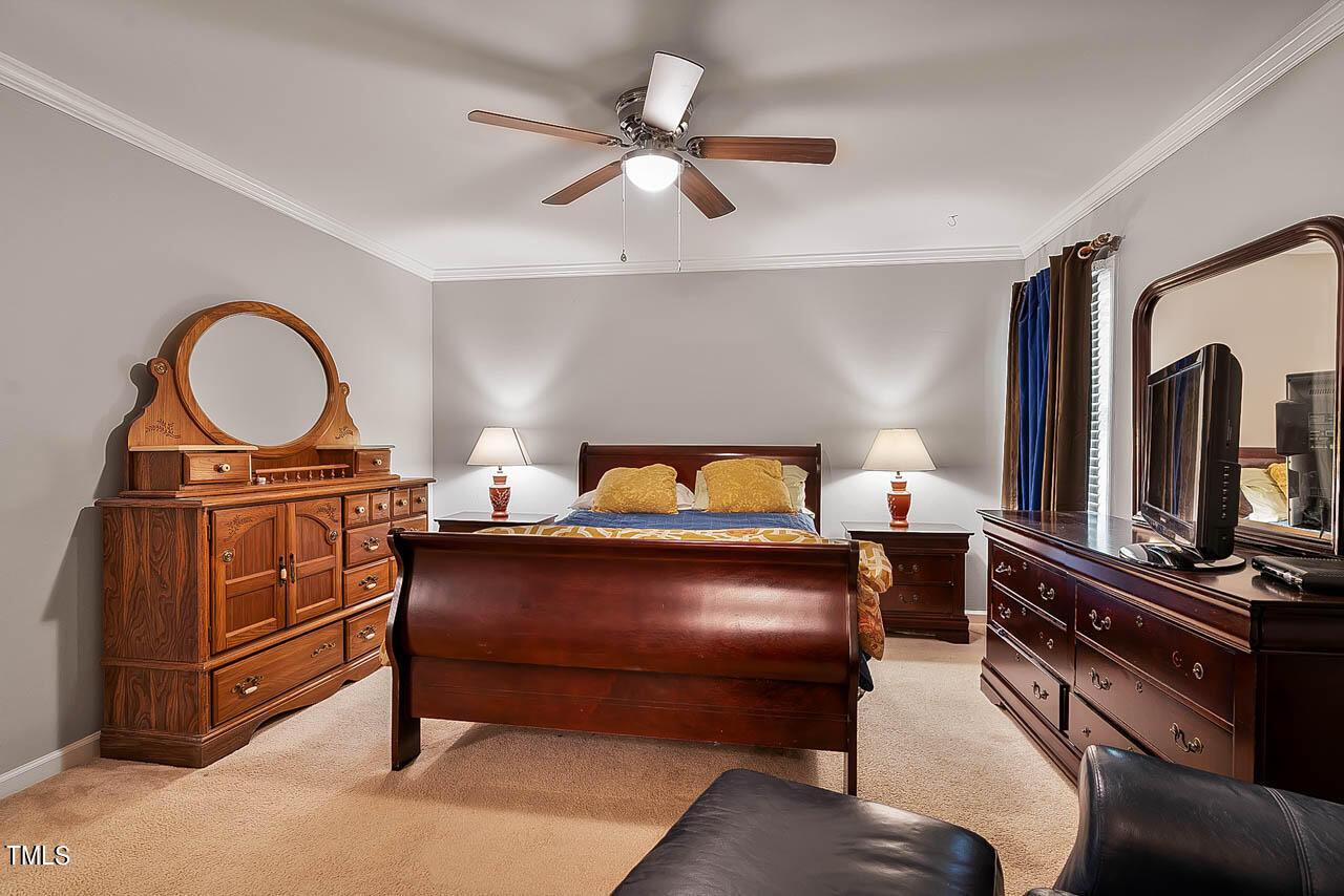 5525 Middleton Road Durham, NC 27713 - Photo 32 of 38 a bedroom with a bed and dresser with mirror